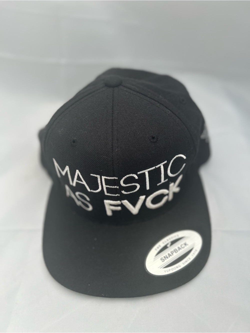 Black Snapback Cap with White 'MAJESTIC AS FVCK' Embroidery